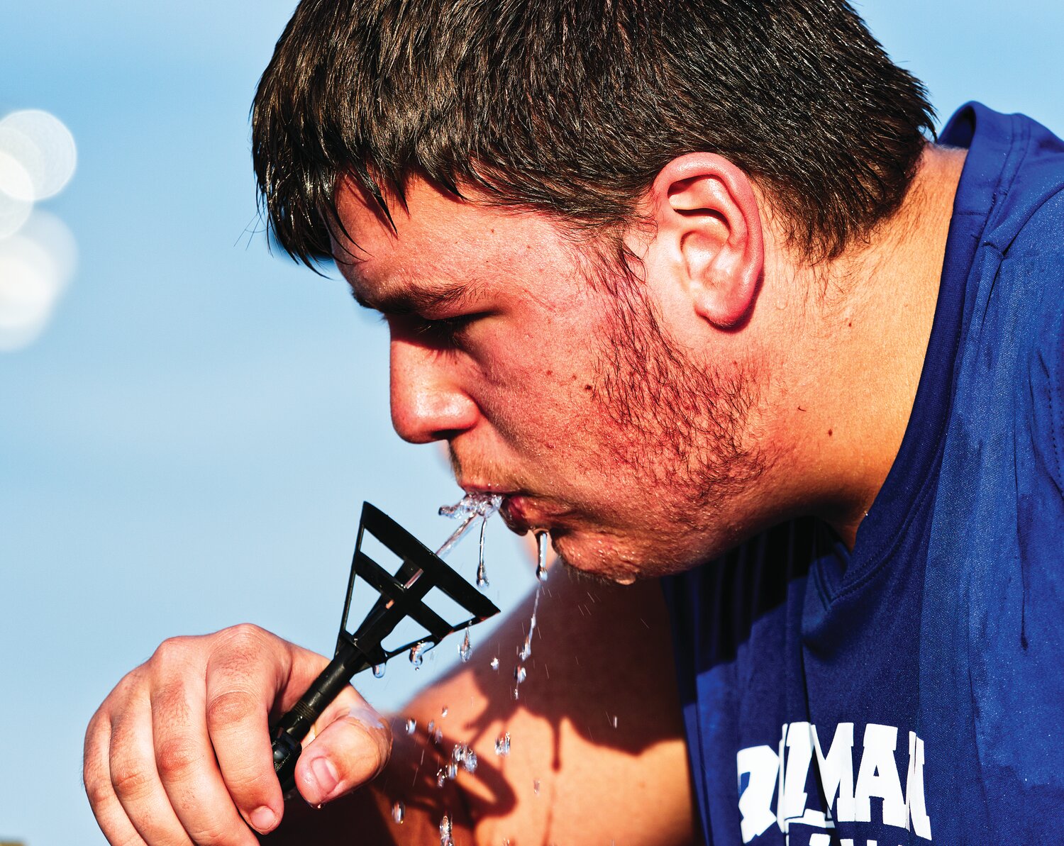 Quitman High School football player Dax Poe takes a water break during the first day of summer practice Monday evening. The Texas heat has led to plenty of precautions as athletes, band students and others have resumed their routines ahead of the return to classes later this month.